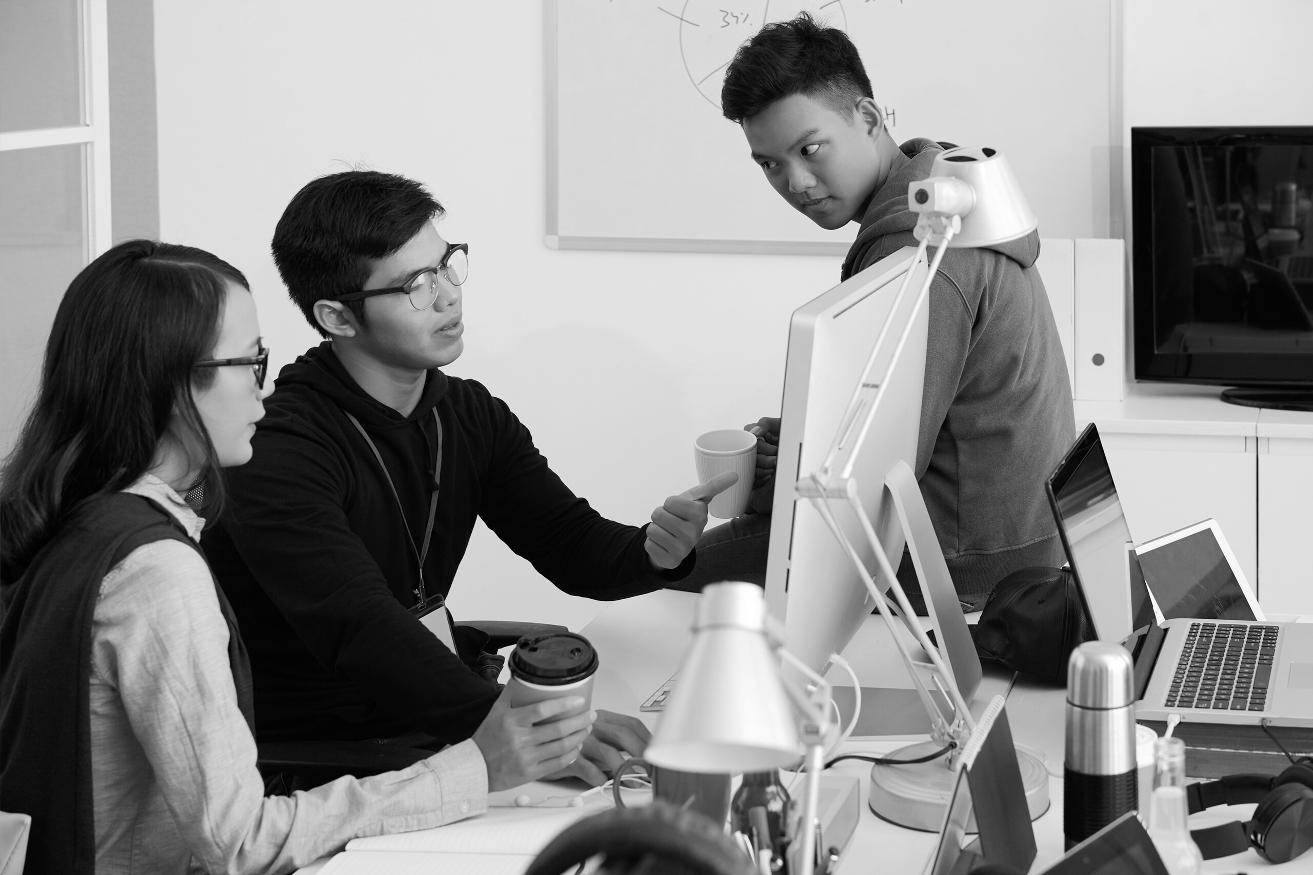 Team meeting around a desktop computer