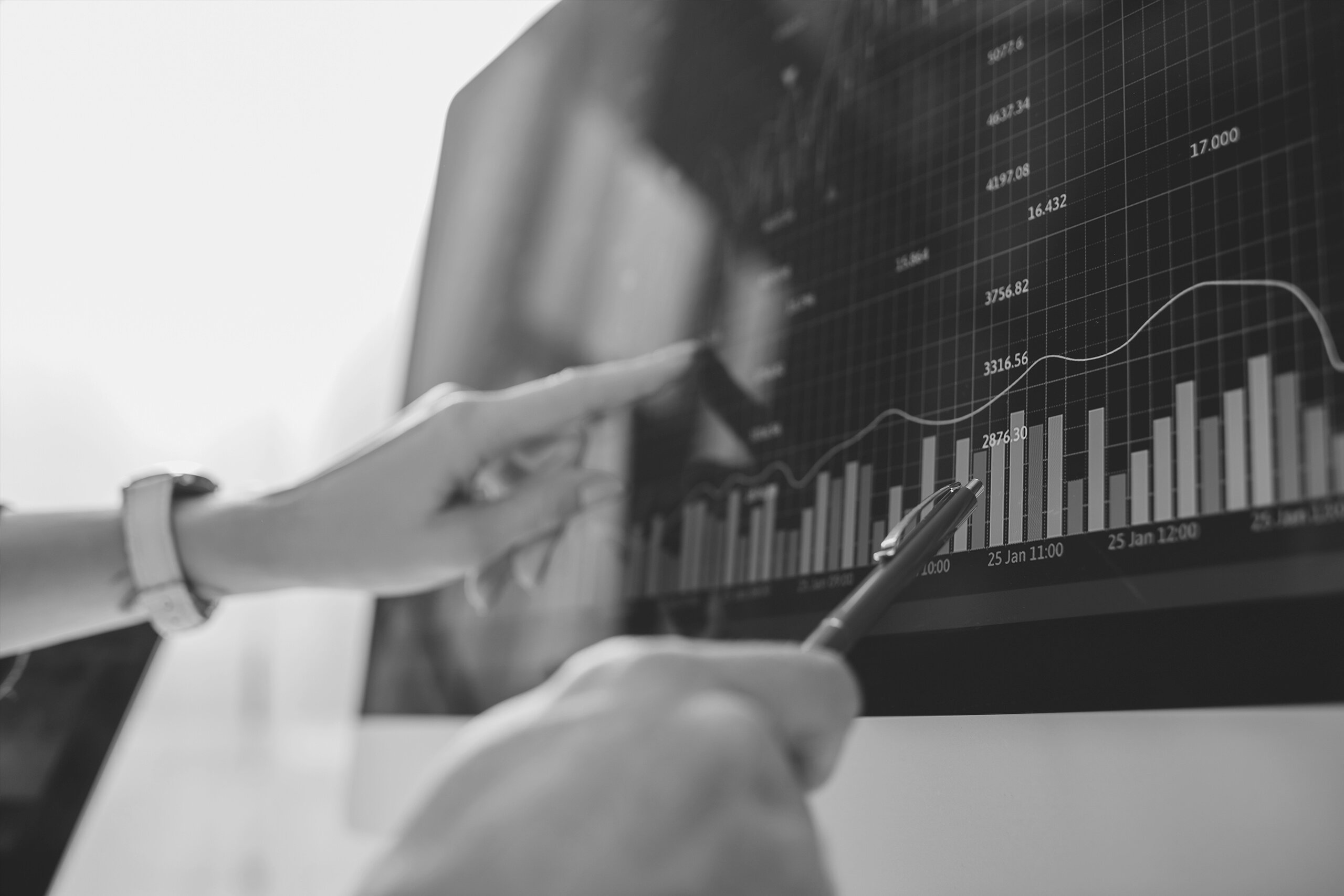 Selective focus of data analysts pointing on graphs on computer monitor