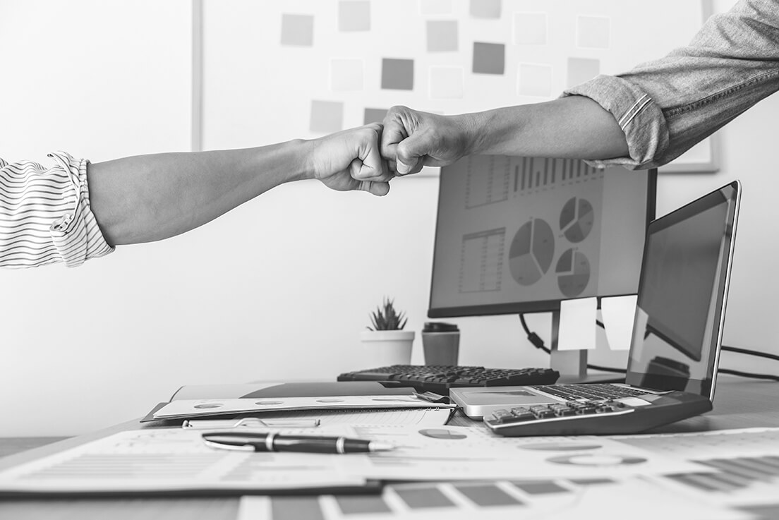 Teamwork of businesspeople giving fist bump to celebrate project